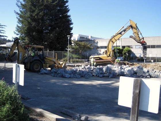 Excavator working a demolition pile