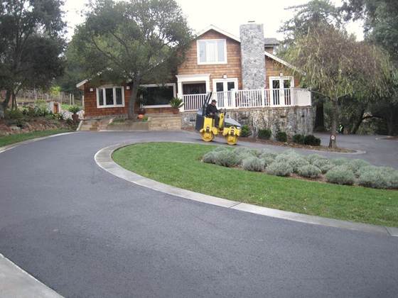 Finished circular asphalt driveway with landscaping