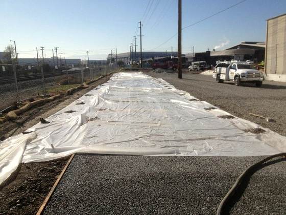 Geotextile fabric laid over a prepared road base