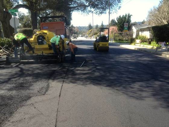 Crew and rollers paving a residential street