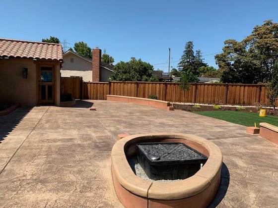 Stamped concrete patio with a built-in fire pit